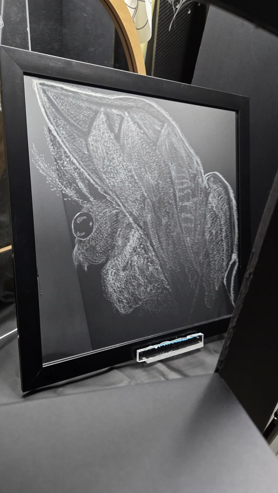 Hand-etched moth mirror with wings spread