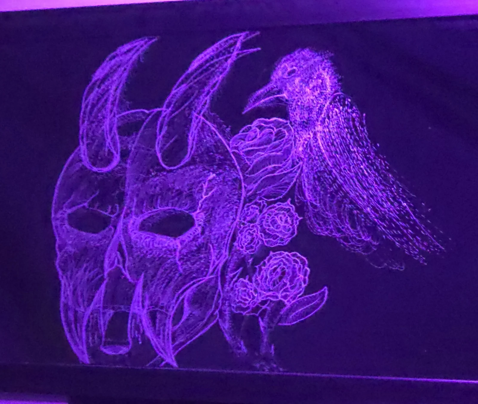 Purple-lit hand-etched mirror: horned skull with a raven and roses